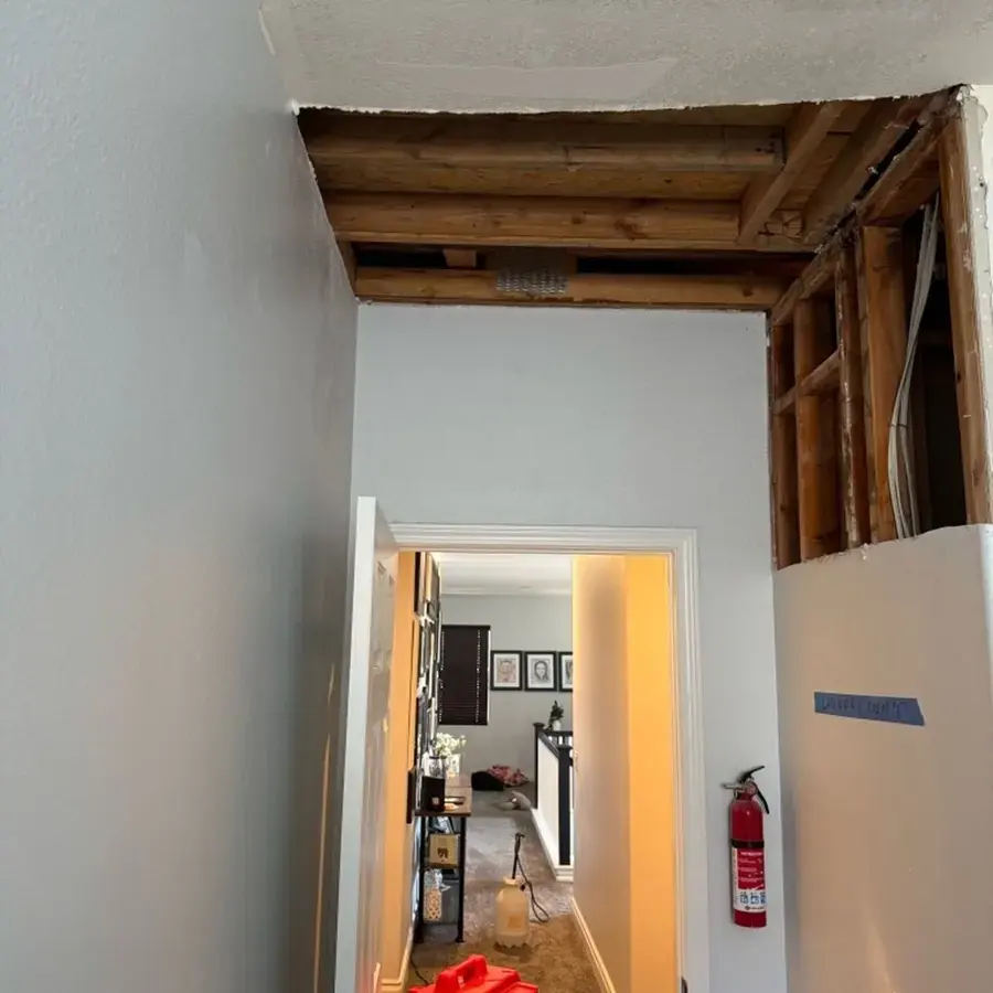 Hallway ceiling opened to dry the framing after an attic leak in Lake Elsinore