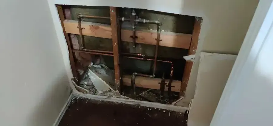 Wall opened to reach leaking copper supply pipes in a Lake Elsinore home