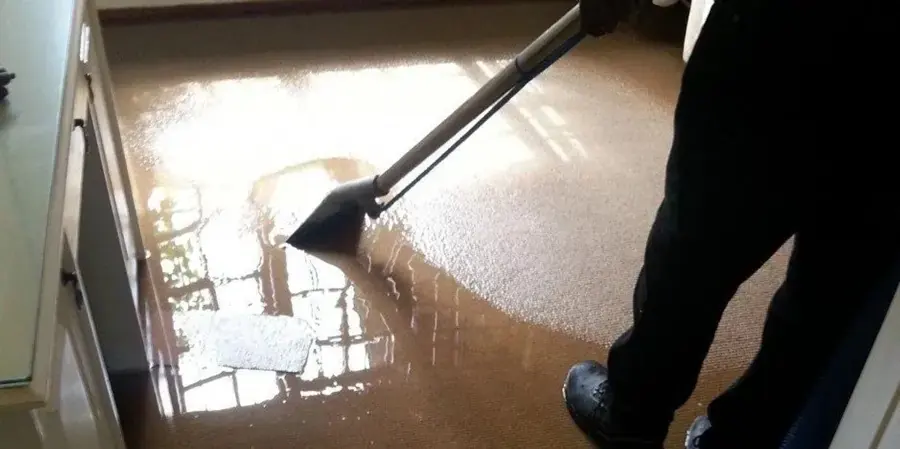 Extraction wand pulling standing water off a flooded tile floor in Lake Elsinore